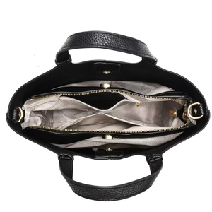 Internal view of black tote bag showing compartments with light herringbone lining