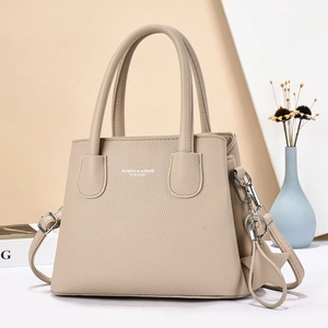 Elegant beige leather handbag with adjustable strap and chic gold star charm detail