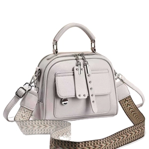 Grey textured leather handbag with silver hardware and versatile woven shoulder strap