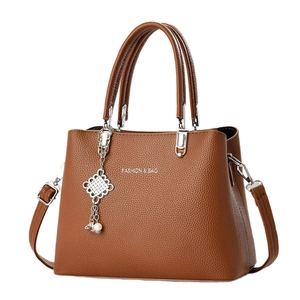 Brown lychee leather tote bag with silver Chinese knot pearl charm and crossbody strap