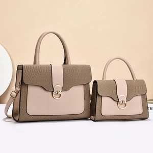 Detail of beige two-piece bag set featuring woven texture and gold circular clasp