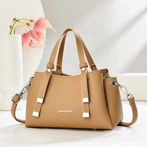 Fashionable camel lychee grain leather tote bag with dual handles and silver hardware