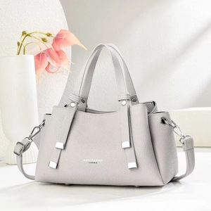 Light gray pebbled leather tote bag with silver hardware and adjustable shoulder strap