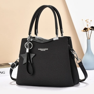 Elegant black woven leather tote bag with star charm and crossbody strap for women