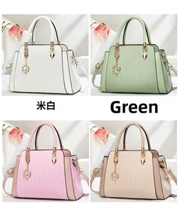Detailed view of four textured tote bags in cream, green, pink, and beige with gold charms