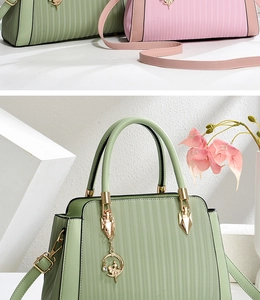 Detailed view of textured tote bag featuring vertical embossing and gold ballerina charm
