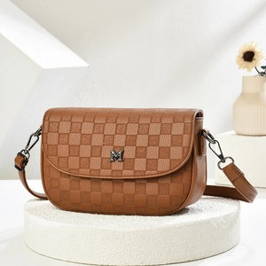 Detail of brown plaid crossbody bag with metal M logo and adjustable shoulder strap