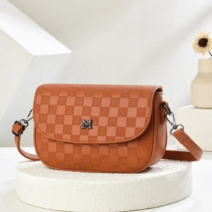 Detail view of brown checkerboard pattern and silver metal M logo on shoulder bag