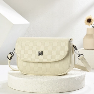 Chic beige checkered crossbody bag with adjustable strap and metal M buckle on a stone base