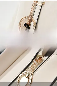 Detail of high-quality gold hardware with clover charm and rust-resistant metal zipper