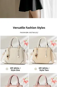 Detailed close-up of textured tote bag with four-leaf clover charm and gold hardware