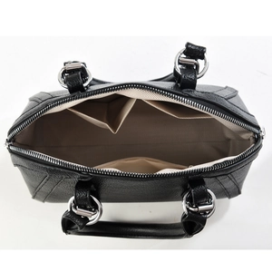 Fashionable black patchwork handbag with spacious interior compartments and silver rings