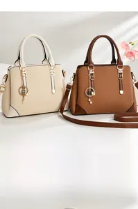 Close-up of woven texture handbags with pearl clover charms and gold hardware details