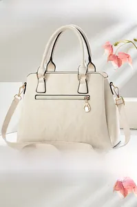 Side and back view of a creamy white textured crossbody bag with gold-tone hardware detail