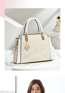 Macro detail of large capacity floral tote with marble texture and elegant moon pendant