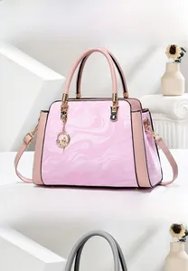 Detailed macro view of pink marble print tote bag with gold hardware and charm