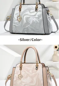 Detailed view of silver and beige marble patterned tote bags with golden hardware