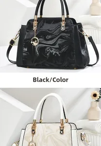 Detail of marble texture handbags in black and beige with gold hardware and doll charm