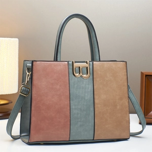 Detailed shot of tricolor leather handbag with a large gold B buckle and dual handles
