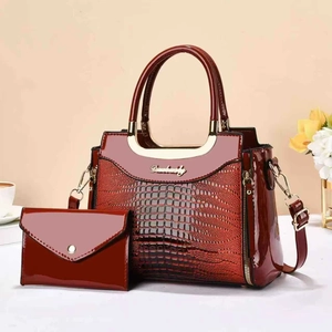 Burgundy faux crocodile leather handbag set with gold handles and matching envelope clutch