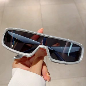 Close-up of matte silver futuristic sports sunglasses with sleek wrap-around shield lens