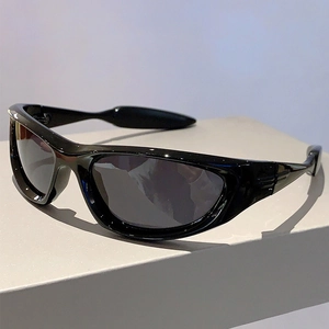 Close-up of black wrap-around sports sunglasses with high-gloss finish and dark lenses