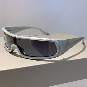 Detail view of futuristic wrap-around sunglasses with matte gunmetal frame and dark lenses