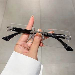 Detail of rimless rectangle sunglasses showing temple specs 55-17-148 and CE marking