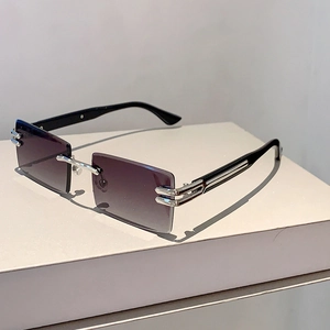Detail of rimless rectangular sunglasses with purple gradient lenses and silver metal hinges