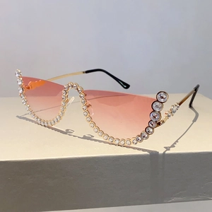 Detailed view of pink gradient cat-eye sunglasses with rhinestone-embellished half-frames