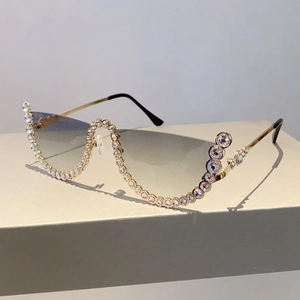 Detailed view of luxury rimless sunglasses with gradient lenses and crystal embellishments