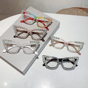 Close-up of cat-eye glasses frames with large sparkling rhinestones on top edges