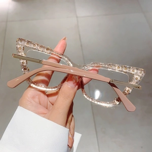 Detail of cat eye glasses frame with sparkling crystals and transparent resin finish