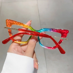Detail of rainbow gradient cat eye glasses frame with sparkling dot accents and gold temples