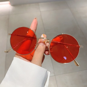 Retro round steampunk sunglasses with gold metal frame and transparent red lenses