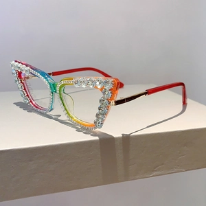 Macro view of rainbow gradient cat eye frames with luxury rhinestone inlay and gold temples