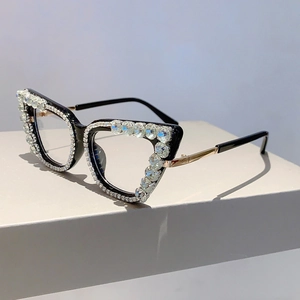 Detail of luxury cat-eye glasses frame with rhinestones and gold metal temples