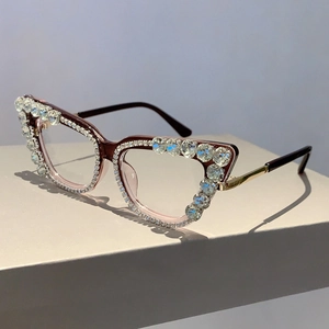 Close-up of cat-eye glasses frame featuring luxury rows of sparkling rhinestones and metal