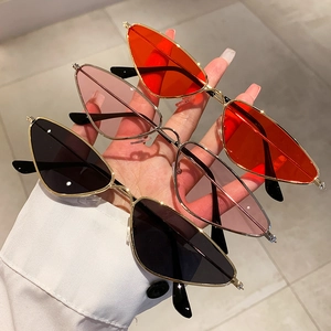 Three pairs of trendy narrow cat-eye sunglasses with colorful lenses and gold metal frames