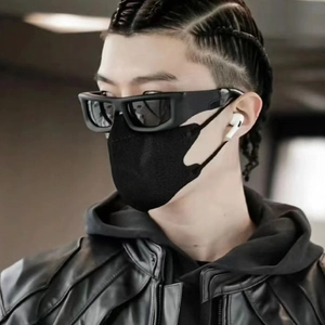 Close-up profile of a black techwear face mask paired with stylish punk sunglasses