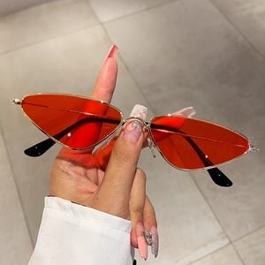 Fashionable narrow cat-eye sunglasses with gold metal frame and red transparent lenses