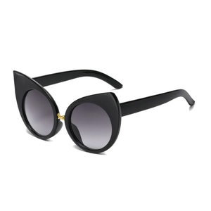 Retro oversized cat-eye sunglasses with glossy black frames and gold bridge accent