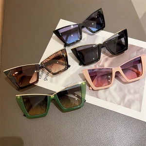 Detailed flat lay of cat eye sunglasses in five colors with stylish gold metal top bars