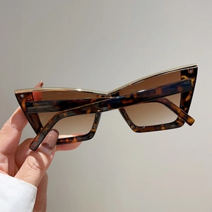 Fashionable tortoise shell cat-eye sunglasses with brown gradient lenses and gold trim