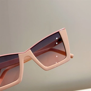Close-up of pink cat-eye sunglasses with gradient lenses and premium resin frame