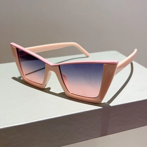 Pink cat-eye sunglasses with blue-pink gradient lenses on a grey display stand