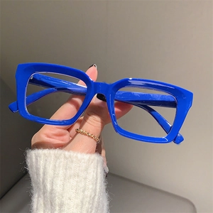 Close-up of chunky royal blue square glasses frames with high-gloss finish details