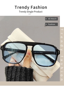 Détail de lunettes de soleil carrées avec verres bleus et un étui en cuir beige