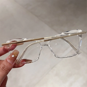 Stylish geometric faceted blue light blocking glasses with gold temples and clear frames