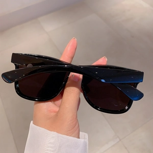 Detail view of stylish rimless black rectangular sunglasses with premium glossy frames